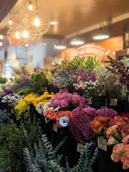 Beautiful display of fresh cut floral stems, in the background is Central Market Lancaster.